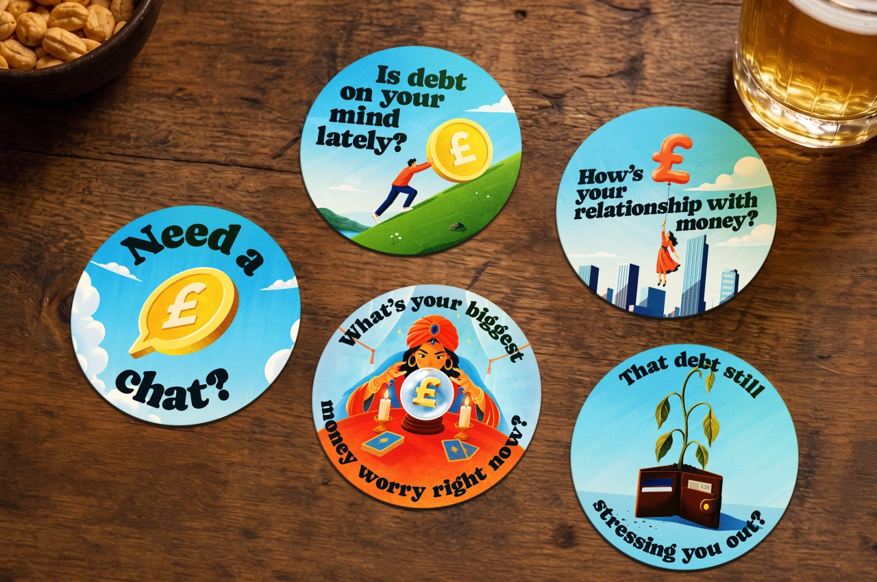 Five illustrated coasters with pound sterling symbols and messages about debt, including "Need a chat?", "Is debt on your mind lately?" and "That debt still stressing you out?